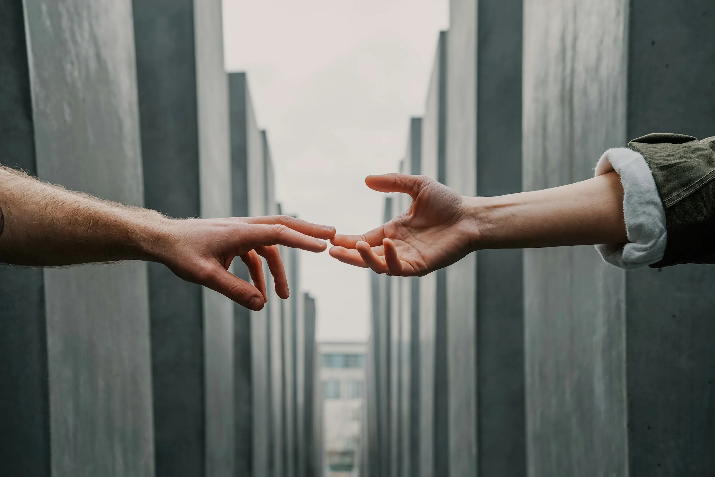 Hand reaching out for help, touching a hand offering help